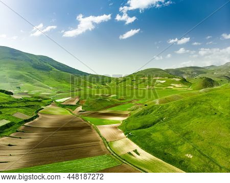 Aerial View Of Piano Grande, Large Karstic Plateau Of Monti Sibillini Mountains. Beautiful Fields Of
