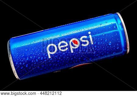 Blue Pepsi Can With Water Drops On The Surface Isolated On A Black Background. A Classic Usa Beverag