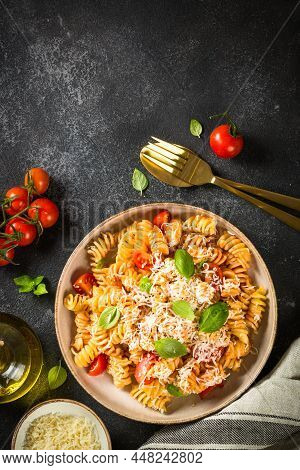 Traditional Italian Kitchen. Italian Pasta Alla Arrabiata With Basil And Parmesan On Dark Table. Top