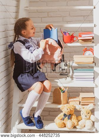 Cute School Girls Packing Their School Bags, Preparing For The First Day Of School. The Morning Scho