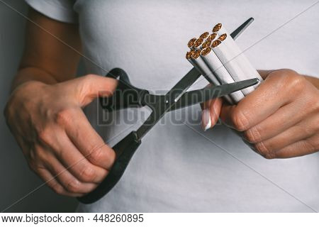 Woman Cutting With Scissors Cigarettes. Stop Smoking, Quit Smoking Or No Smoking Concept. Woman Refu