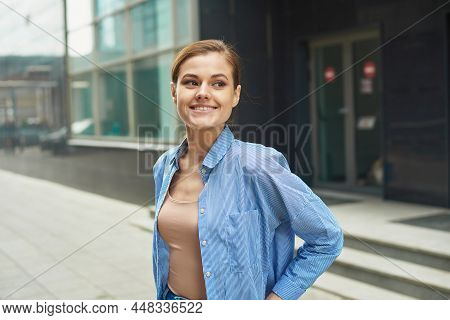 Happy Confident Business Woman Walking Out Of Modern Office Center. Portrait Of Successful Enterpren