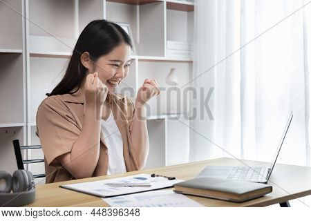 Joyful, Surprised Or Shocked Asian Woman Raised Her Arms All The Way Because She Did A Good Job The 