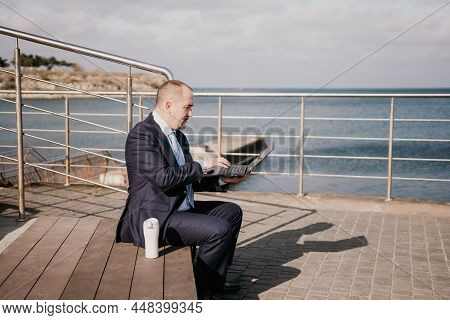 Confident Middle Age Businessman Working Remotely Online, Typing On A Laptop Keyboard While Sitting 