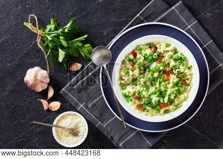 Risi E Bisi, Venetian Risotto With Spring Peas And Chunks Of Ham In A Bowl On A Concrete Table With 