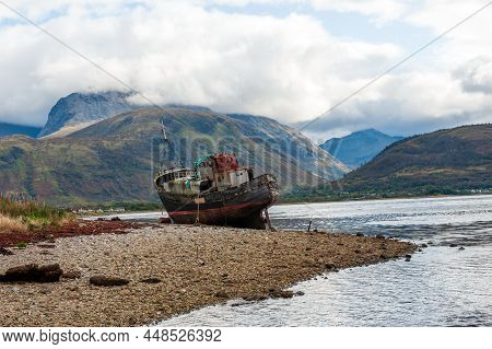 The Old Fishing Boat On The Shingled Shoreline Of Loch Linnhe Near Fort William , Scotland Highland,