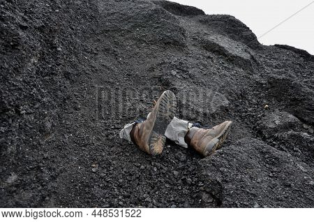 Large Pieces Of Asphalt Partially Cover The Figure Of A Man Under The Rubble. Skydiving Backfill At 