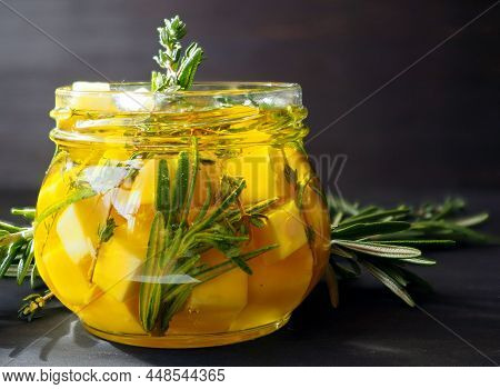 Marinated Cheese With Rosemary, Thyme In Olive Oil. 
Traditional Mediterranean Snack. On A Dark Wood