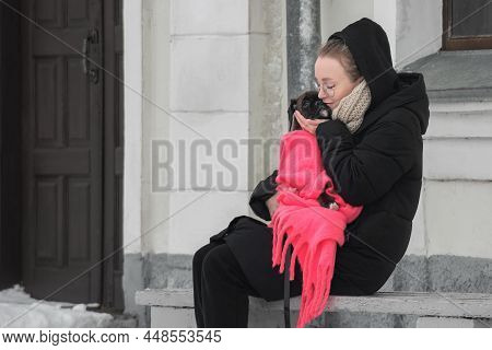 A Beautiful Young Girl With Glasses Gently And Lovingly Hugged Her Little German Boxer Puppy For A W