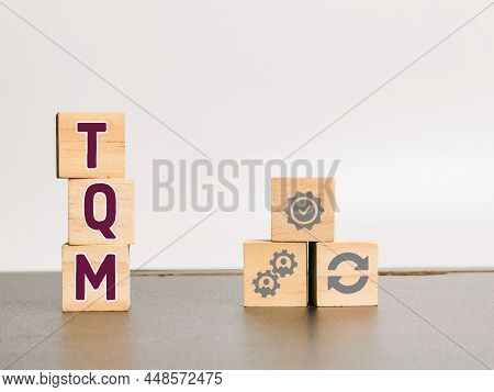 Total Quality Management Concept With Symbols On Wooden Cubes. Selective Focus.