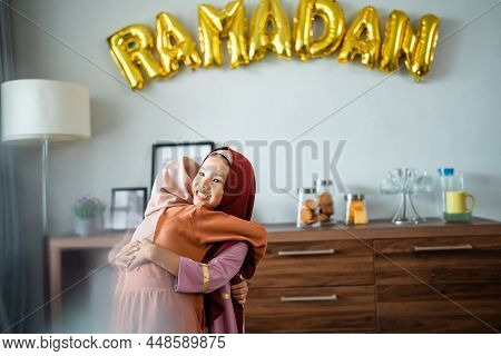 Two Little Young Girl With Headscarf Embracing Each Other