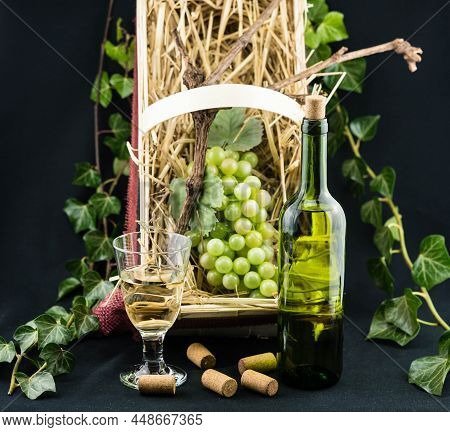 Wine Bottle, Glass A Corksrew And Grapes