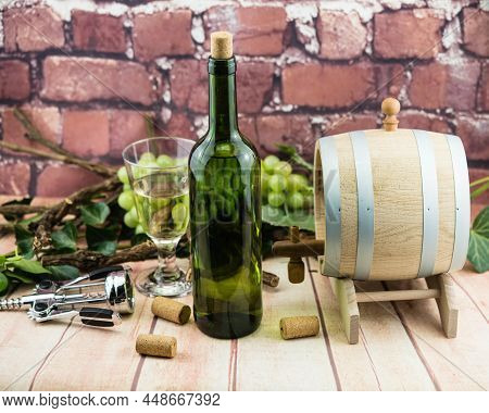 Wine Bottle, Glass A Corksrew And Grapes
