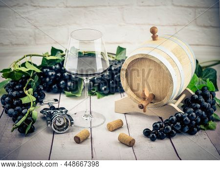 Wine Bottle, Glass A Corksrew And Grapes