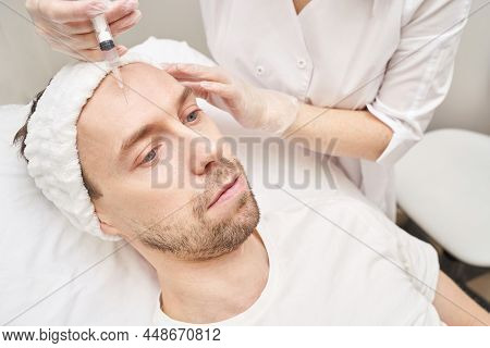 Injection At Spa Salon. Doctor Hands In Gloves. Closeup. Pretty Male Patient. Beauty Treatment. Heal