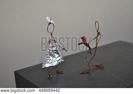 Handcrafted Wire Man Giving Flowers To Wire Woman. Kids Crafts Made From Reused Copper Wire And Foil