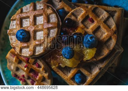 Croissant Waffle Or Croffle With Srawberry And Blueberry Sauce Served In Plate And Dark Background. 