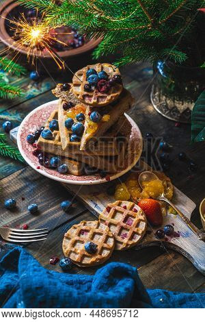 Croissant Waffle Or Croffle With Srawberry And Blueberry Sauce Served In Plate And Dark Background. 