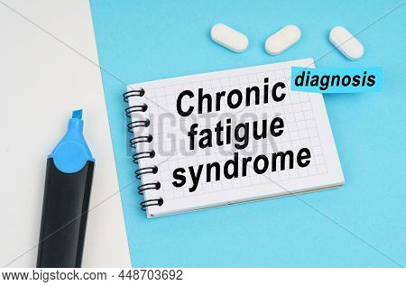 Medicine And Health Concept. On A White And Blue Surface Are Pills, A Marker And A Notebook With The