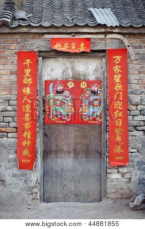 Old wooden door with fortune poster, China