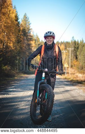 Young Likeable Lady With A Lovely Realistic Smile While Recreationally Sporting. Cyclist Riding Fat 