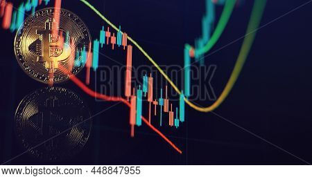 Cryptocurrency Bitcoin Gold Coin And Defocused Chart Background.