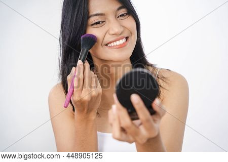 Woman Applying Make Up Powder And Blush On Her Cheeks