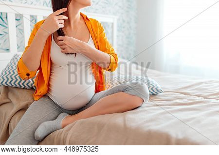 Pregnant Woman In Bed On Bright Background.