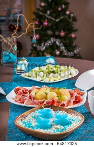 Holiday-decorated Table, Christmas Tree, Ham And Melone, And Salad