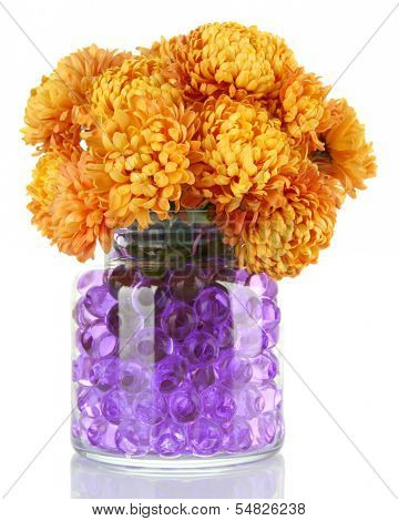 Beautiful flowers in vase with hydrogel isolated on white