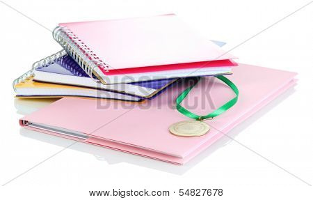 Medal for achievement in education and notebooks isolated on white
