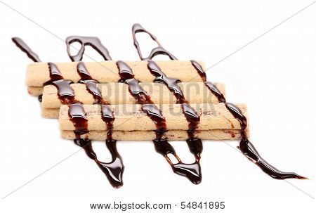 Stream chocolate on stics of biscuit.