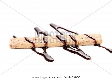 Stream chocolate on stics of biscuit.