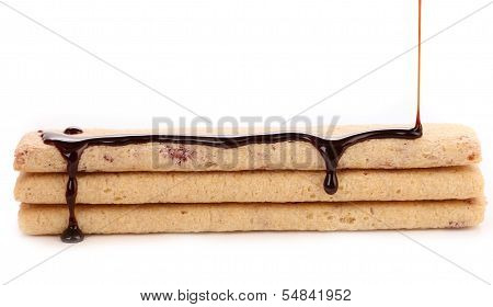 Stream chocolate on stics of biscuit.