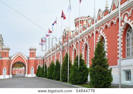 Flagpoles along the wall with pointed windows of the Petroff Palace in Moscow. Palace was built in the 18th century