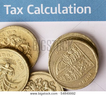 A heap of British pound coins, showing the Welsh leek and the coat of arms of the UK, on a British tax office form.