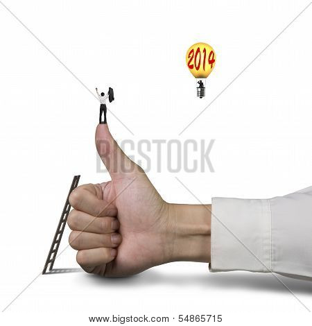 Businessman On Top Of Thumb, Another Standing In Balloon With 2014