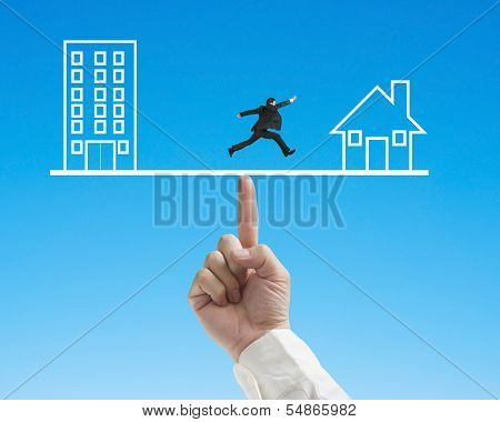Office And Home On Seesaw With One Businessman Running