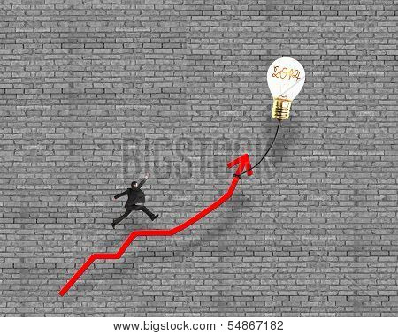 Businessman Jumping On Growth Red Arrow With Glowing Lamp Balloon