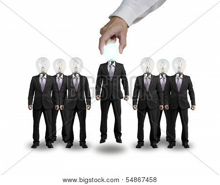 Hand Grab And Lift One Businessman With Lighting Bulb Head