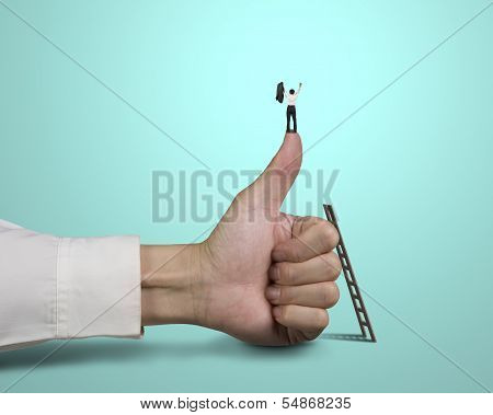 Businessman Standing On Top Of Thumb With 2 Hands Up
