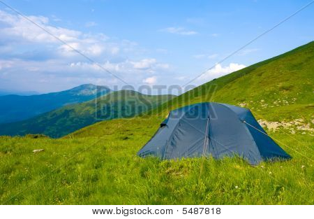 Tourists Tent In Mountains Camp