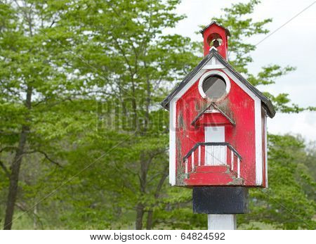 Red well worn birdhouse