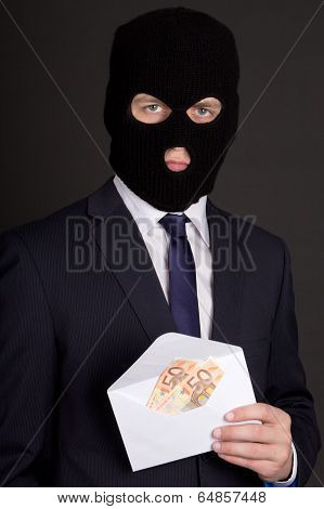 Bribery Concept - Man In Business Suit And Mask Holding Envelope With Euro Banknotes