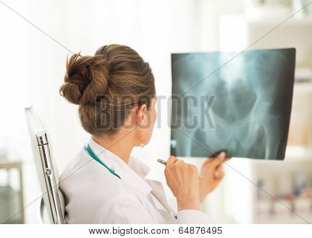 Medical Doctor Woman Looking On Fluorography. Rear View