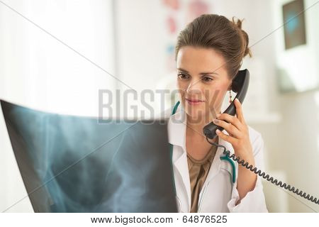 Medical Doctor Woman Looking On Fluorography And Talking Phone