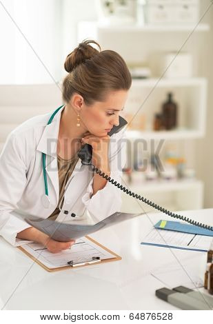 Thoughtful Medical Doctor Woman With Fluorography And Holding Ph