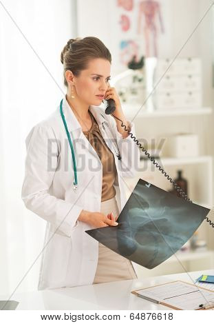 Medical Doctor Woman With Fluorography Talking Phone In Office