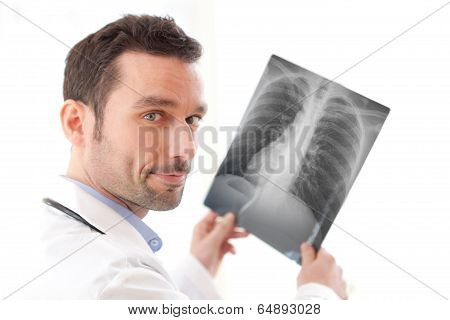 Portrait Of A Young Doctor Analysing A Radiography