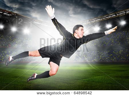 soccer or football goalkeeper is catching ball on stadium